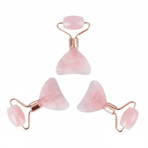 Set of three pink rose quartz facial rollers and gua sha tools for skincare massage