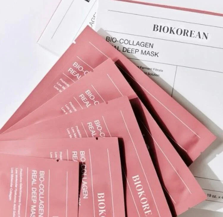 Stack of Biokorean Bio-Collagen Real Deep Mask sheets in pink packaging for premium skincare treatment